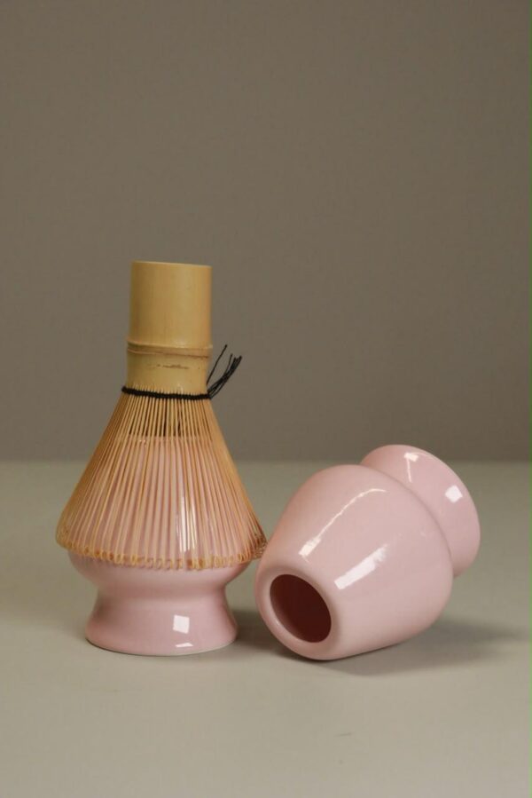 Bamboo chasen whisk on a pink ceramic stand